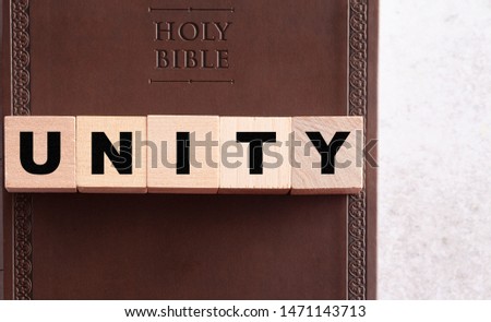 Unity Spelled in Blocks on a Brown Leather Holy Bible