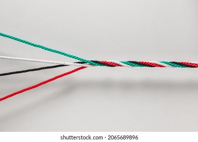 Unity and strength of Emirates- a concept for UAE National Day Celebration Day. Many cords with UAE National flag colors twisted together as one strong rope.