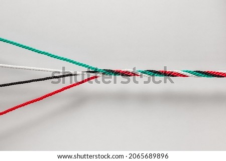 Unity and strength of Emirates- a concept for UAE National Day Celebration Day. Many cords with UAE National flag colors twisted together as one strong rope.
