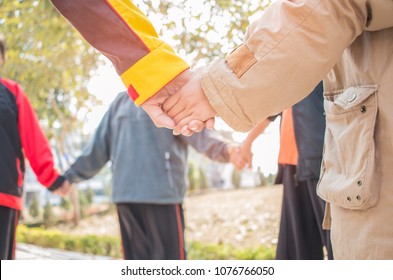 Unity and teamwork Concept: Blurred of Group students hands together in activities outdoor classroom. View of Asian young childrens putting hand together show teamwork to success learning in school