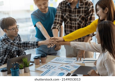 Unity and Teamwork Concept. Cooperation of young business people in the office.