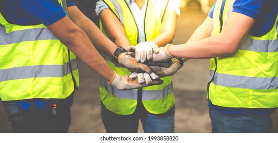 Unity and teamwork concept. team standing hands together. Professional Mechanical Engineer team Working at Second-hand spare parts of old car parts warehouse store.  - Powered by Shutterstock