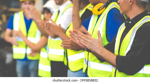 Unity and teamwork concept. team standing hands together. Professional Mechanical Engineer team Working at Second-hand spare parts of old car parts warehouse store. Celebrate clapping - Powered by Shutterstock