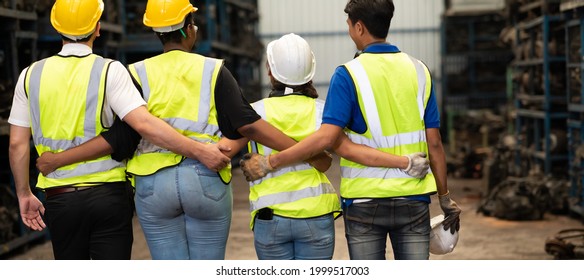 Unity and teamwork concept. team standing hands together. Professional Mechanical Engineer team Working at Second-hand spare parts of old car parts warehouse store. High five. - Powered by Shutterstock