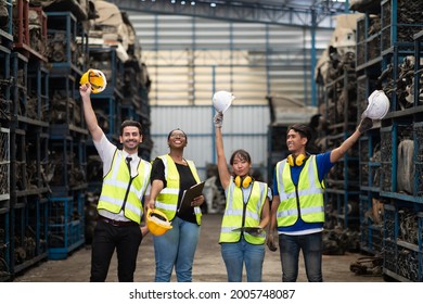 Unity and teamwork concept. team standing hands together. Professional Mechanical Engineer team Working at Second-hand spare parts of old car parts warehouse store. High five. - Powered by Shutterstock