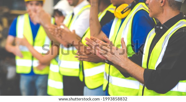 Unity and\
teamwork concept. team standing hands together. Professional\
Mechanical Engineer team Working at Second-hand spare parts of old\
car parts warehouse store. Celebrate\
clapping