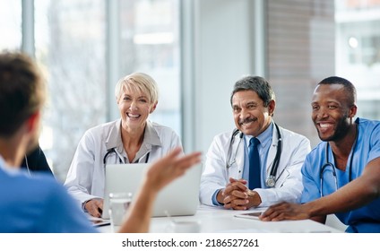 Unity, Teamwork And Happy Health Care Workers Having A Meeting In A Conference Room. Diverse Doctors Discussing Modern Treatments And Innovation, Brainstorming To Find A Cure For Sickness And