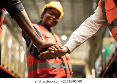 Unity warehouse teamwork concept. Team standing hands together. Professional warehouse engineer team working at store - Powered by Shutterstock