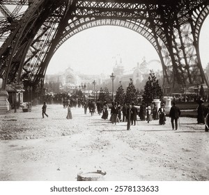 Universal Exhibition of 1900: characters under the Eiffel Tower, and perspective of the Champ-de-Mars, Paris, vintage photograph. Vintage Eiffel Tower street art photograph, old Eiffel Tower image art