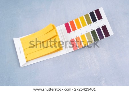 Universal indicator paper with acidic testing, Flat lay.