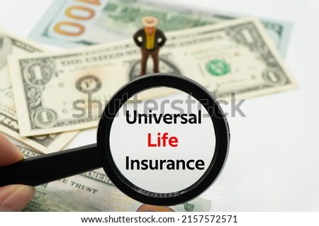 Universal Life Insurance.Magnifying glass showing the words.Background of banknotes and coins.basic concepts of finance.Business theme.Financial terms.