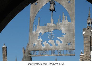 Universal Studios Japan. The Hogwarts castle reflect to the water in The Wizarding World of Harry Potter in Universal Studio Osaka - Powered by Shutterstock