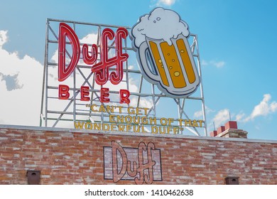 Universal Studios Orlando Florida March 24, 2019 The Simpsons Tv Show Duff Beer Sign With Blue Skies In Background