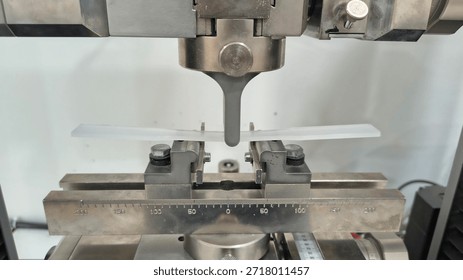 Universal Testing Machine Performing Three-Point Bending Test on Plastic Specimen, Industrial Laboratory Material Strength Analysis, Quality Control and Mechanical Engineering Research Process