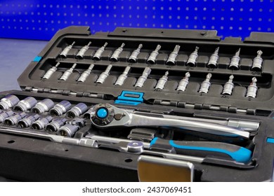 Universal tool box, tool kit closeup with set of hex, torx and screwdriver bits, and various sizes of ratchet wrench sockets