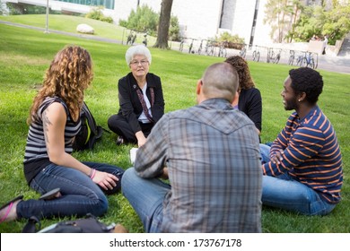 University Class Taking Place Outdoors With Small Group Of Students