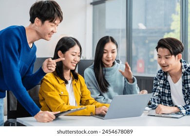 university classroom, diverse group of young students Asian collaborate study together, sharing smiles and insights around desks, exemplifying the joy of learning and friendship in higher education.