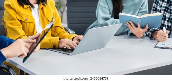 university classroom, diverse group of young students Asian collaborate study together, sharing smiles and insights around desks, exemplifying the joy of learning and friendship in higher education. - Powered by Shutterstock