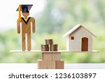 University Education learning abroad international Ideas. Student Graduation, coins and house on wood balance. Concept of study requires money cost saving, may be home loan, transform propery to cash.