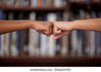 University, education and students in library with fist bump, team project or knowledge on campus. College, support and people with hands together for collaboration, friends and studying at bookshelf - Powered by Shutterstock