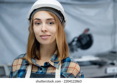 University Graduate Trainee Worker Of Modern Manufacturing Factory Blue Background. Portrait Young Woman Engineer In Hardhat.