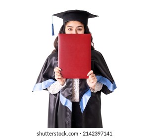 University graduate wearing academic regalia and red diploma with copy space isolated on white. - Shutterstock ID 2142397141