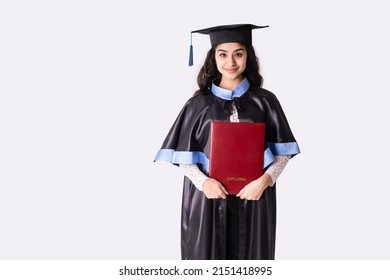 University graduate wearing academic regalia with red diploma. Background with copy space. - Shutterstock ID 2151418995