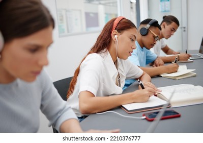 University, Headphones And Students Writing Notes While Listening To Music, Educational Podcast Or Radio Audio. Earphones, College And Group Learning, Studying Or Exam Preparation With Phone On Desk.