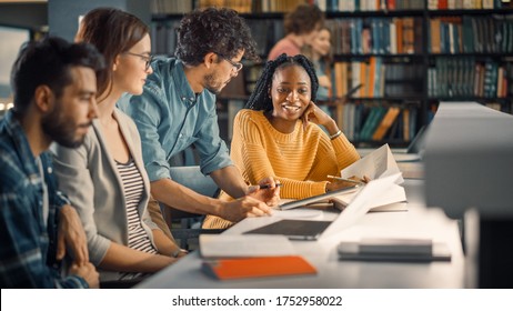 University Library: Diverse Group of Gifted Students Have Discussion, use Laptop, Prepare for Exams Together, Helping, Researching Subjects for Paper Assignment. Happy Young People Study for Future - Powered by Shutterstock