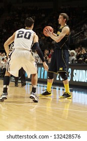 UNIVERSITY PARK, PA -  FEBRUARY 27: Michigan's Nik Stauskas  No. 11 Looks To Pass As Penn State's Nick Colella Defends At The Byrce Jordan Center February 27, 2013 In University Park, PA