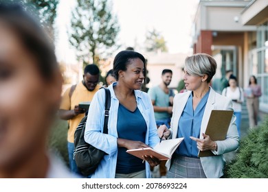 University Professor Communicating With Black Female Student At Campus After The Lecture. 