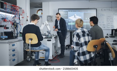 University Robotics Class. White Male Teacher Explaining Engineering To Students And Using Robot Arm. Diverse Group Of Young Engineers Sitting At University. Computer Science Education Concept.