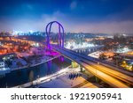 University Route in Bydgoszcz in winter by night. Bridge over Brda river. Aerial view of Poland