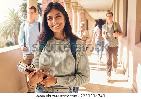 University student, indian woman and portrait at campus outdoor with books of learning, education or knowledge, scholarship and motivation. Happy, smile and young college student, studying or academy