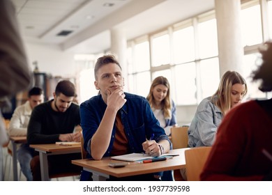 University student listening lecture while attending a class in the classroom. 