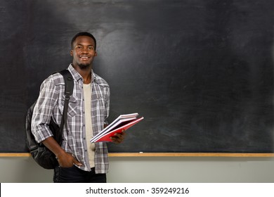 University student posing on blackboard.