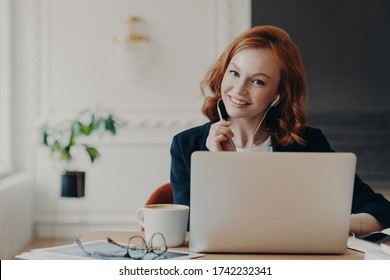 University Student Studies Online From Home, Discusses Project Work With Professor, Poses In Coworking Space And Drinks Aromatic Coffee. Video Conference, Vitrual Event, Online Education Concept