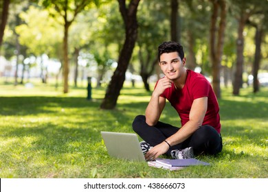 University student studying in park.