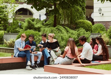 University students from around the world working together on assignments, multiracial boys and girls enjoying study session outdoors. Concept of education, university, multicultural students, unity - Powered by Shutterstock