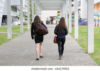 University Students With Backpacks Walking On Campus Road