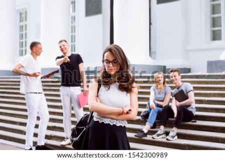 University students bullying their group mate college girl. College students playing pranks and mocking on new learner girl