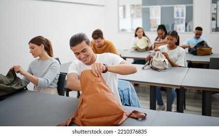 University Students In A Classroom, Learning Education At College In A Diversity Rich Environment. Young Men And Women Are Excited To Study And Learn As They Search For Stationary In Backpack.