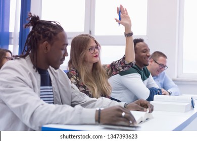 University Students During The Class. Resolving Problems Together. Team Work Concept. One Student With Hand Up.