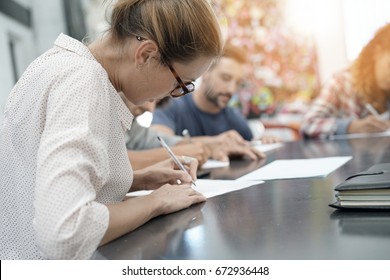 University Students Filling In Application Form            