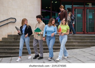 University students leaving the library carrying school supplies - Shutterstock ID 2191374585