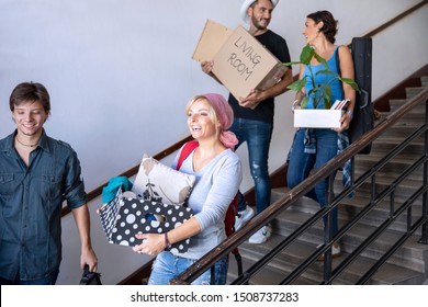 University Students  Moving To New Apartment Carrying Cardboard Box And Stuff. Roommate Friends First Day In College Campus