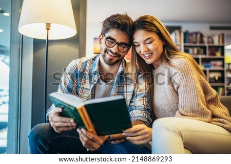 University students talking while learning in a cafe together. 