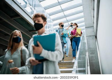 University Students Walking Down The Stairs And Talking Indoors, Coronavirus Concept.