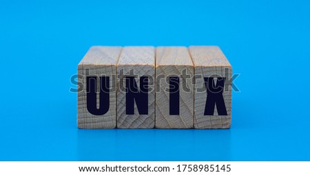 UNIX - word on wooden blocks on a blue background. Technology and computers concept.
