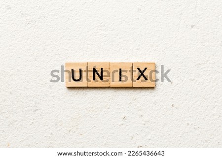 Unix word written on wood block. Unix text on table, concept.